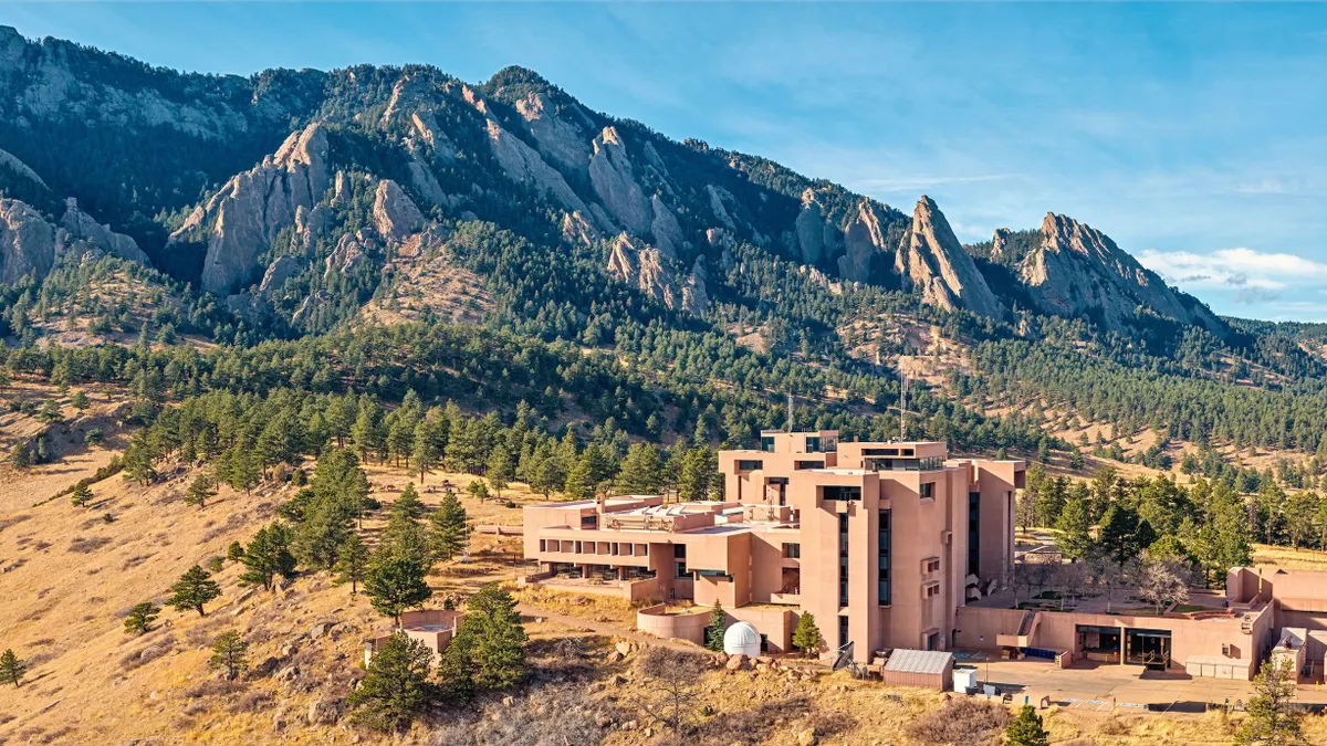 A sprawling building on a mountainside.