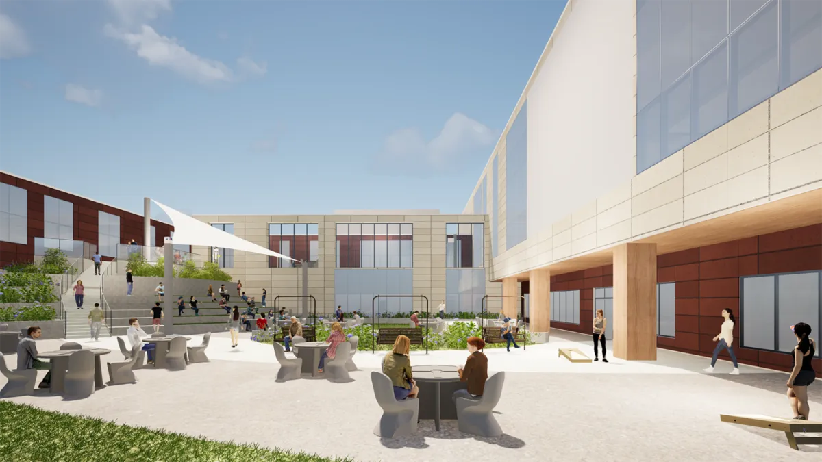 A rendering of a hospital common area outdoors, with tables and chairs on grass and walkways under a blue sky.