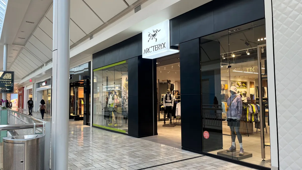 A black Arc'teryx storefront inside an indoor mall.