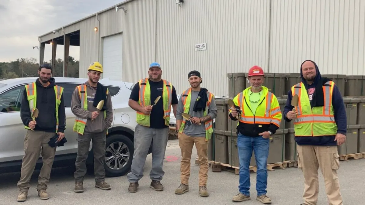 Construction workers pose for a photo.