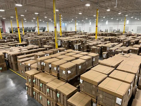 Cardboard boxes stacked in a corrugated packaging warehouse.