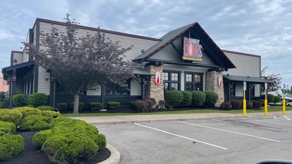 An image of a gray building with a logo that says "Smokey Bones Bar & Fire grill"