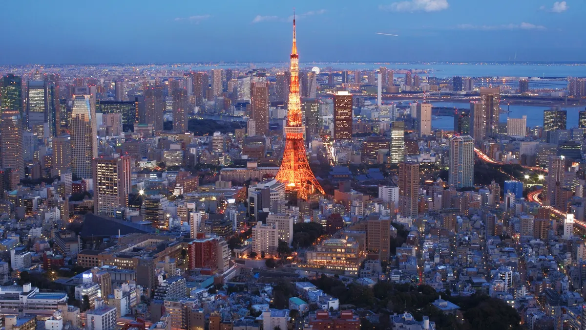 An aerial view of Tokyo Tower and the surrounding area with skyscrapers.