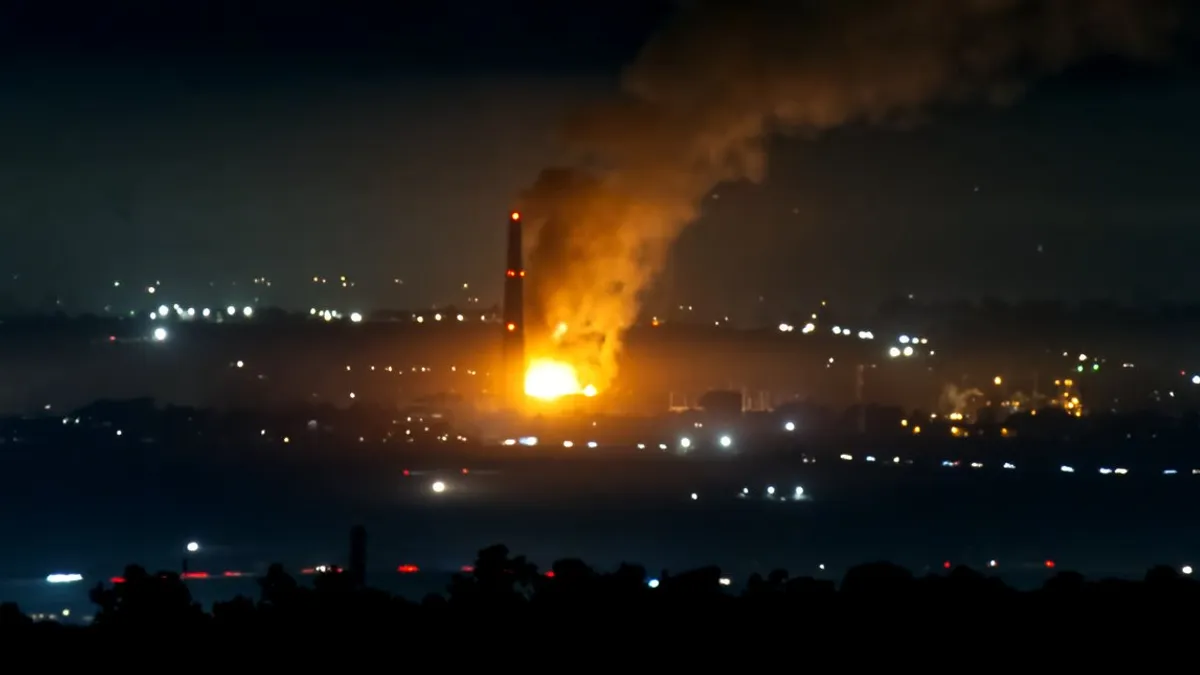 An industrial fire on a dark night.