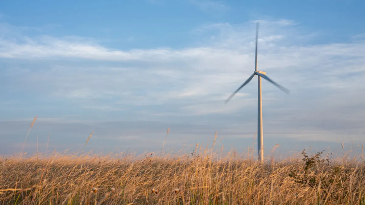 A wind turbine in a field at dawn on June 28, 2024 in Nolan, Texas.