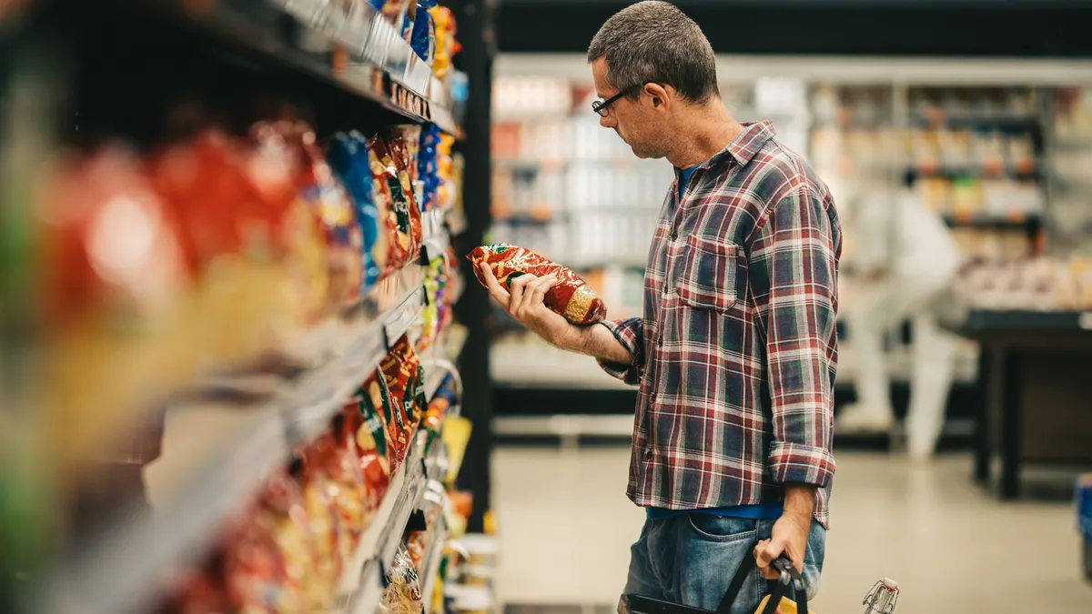 A consumer looks at food packaging