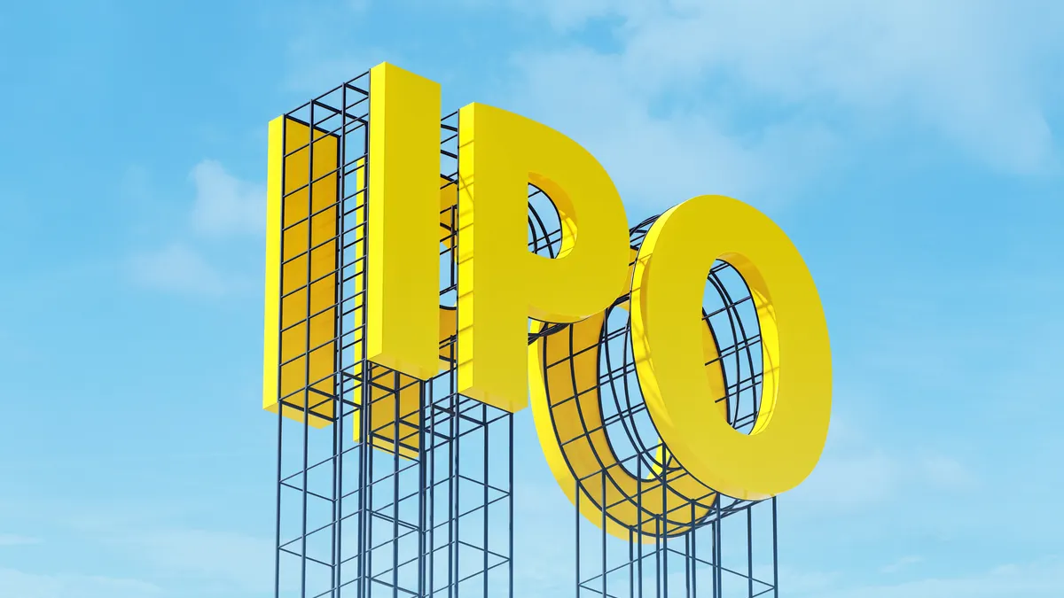 Large yellow signboard on metal frame with the word IPO. Clear sky in the background.