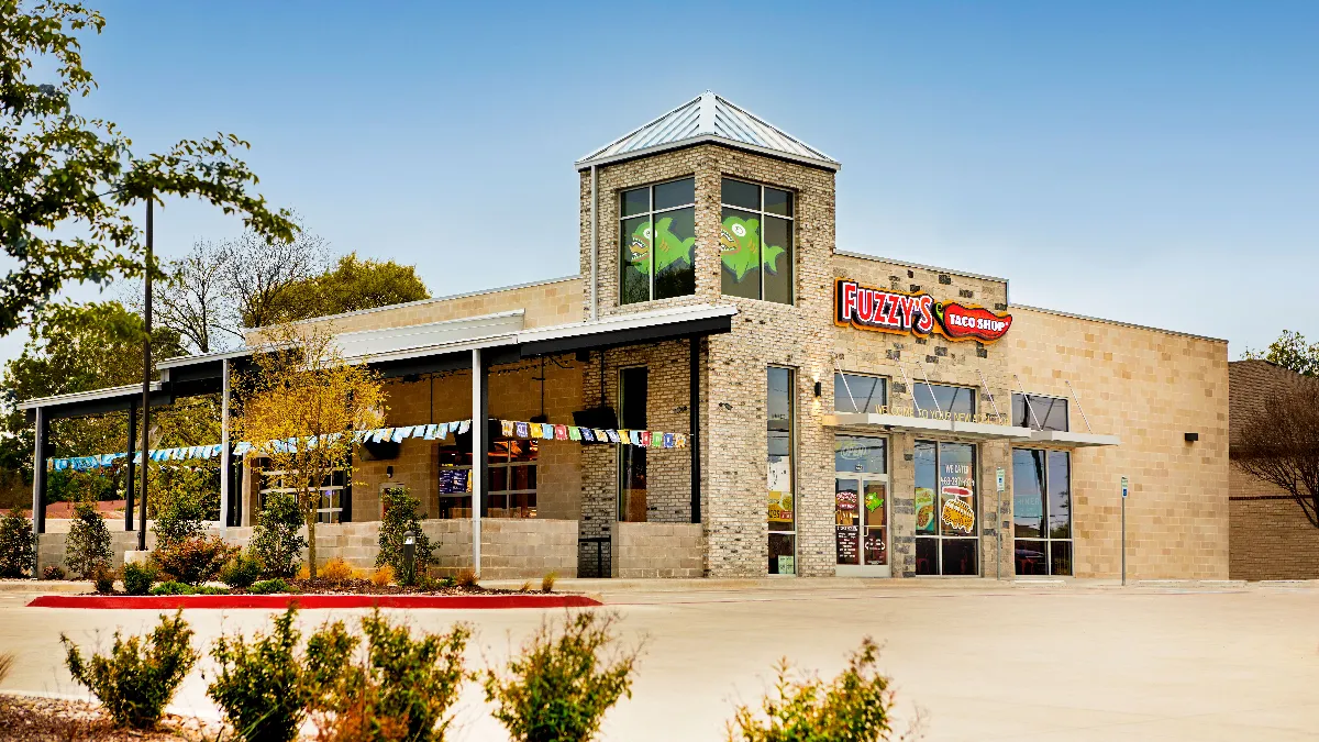 An image of a building with Fuzzy's Taco Shop logo.