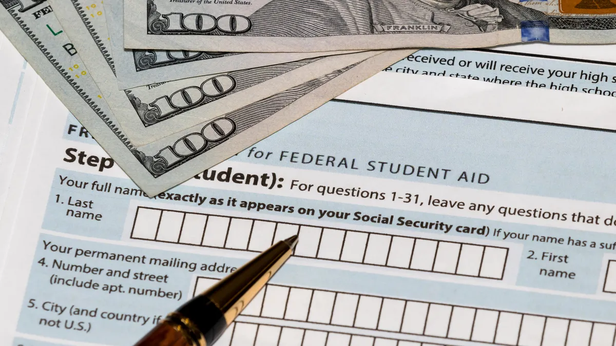 A federal financial aid form with several $100 bills.