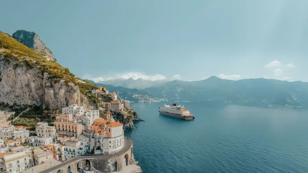 A cruise ship sails around the Amalfi Coast