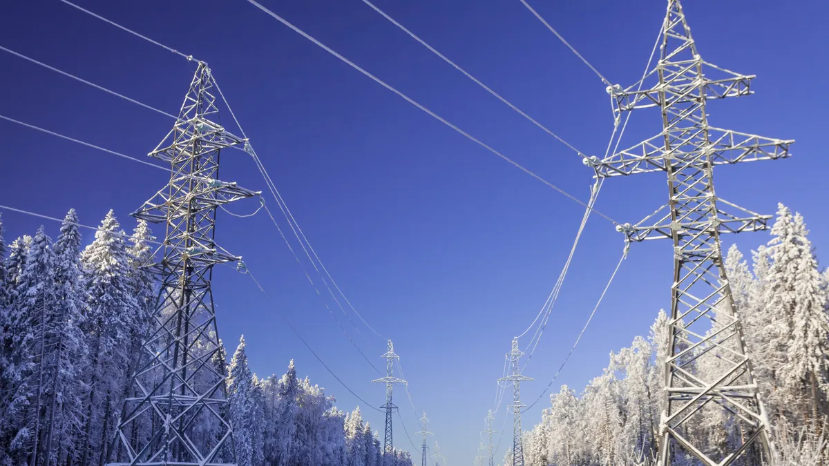 The overhead electric line over blue sky