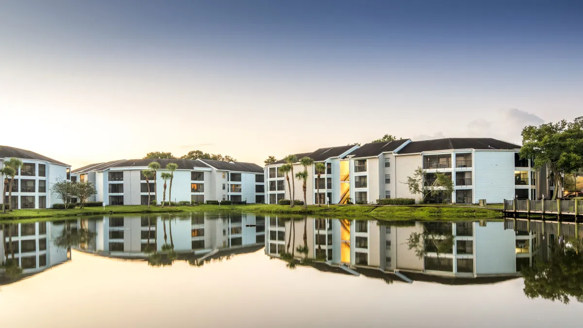 white apartments with a lake in the foreground