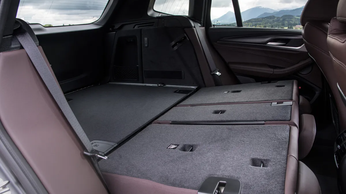 The cargo area of a 2022 BMW X3 SUV showing the rear seat backs folded down.