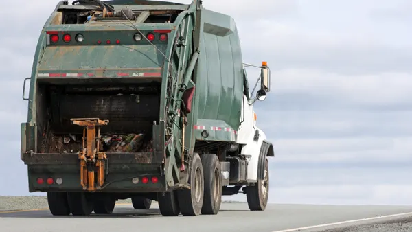 A waste management truck hauls another load of solid waste to a landfill site.