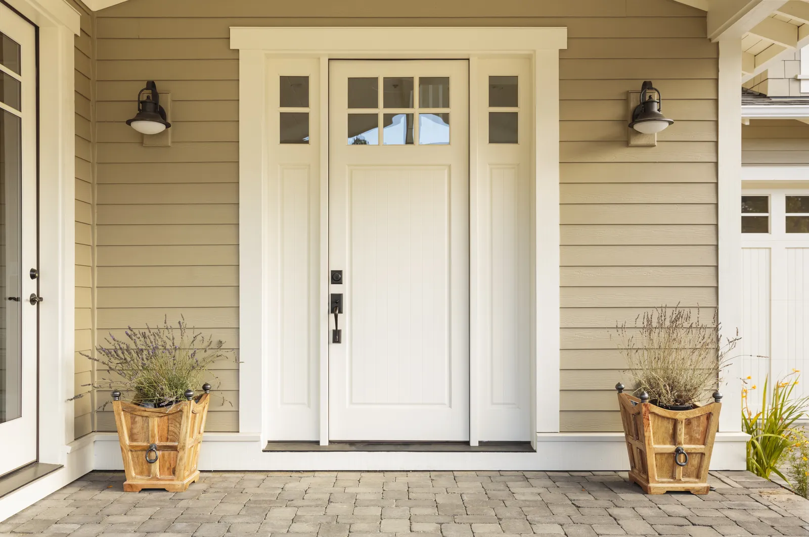 A front door of a home with beige siding.