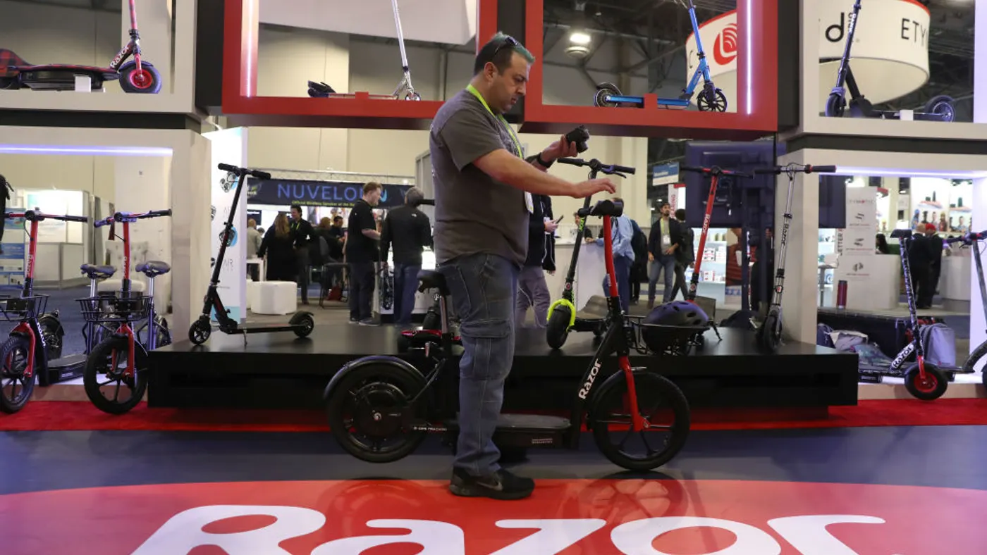A man inspects an electric scooter