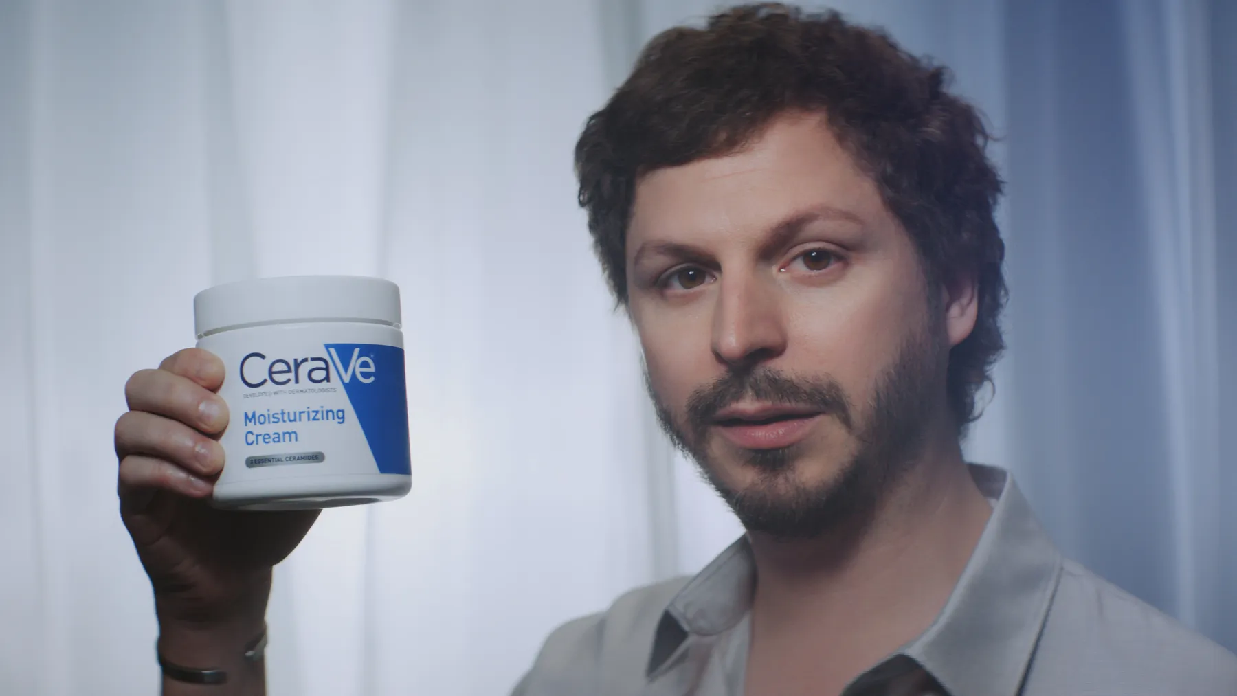 Actor Michael Cera holds a tub of CeraVe lotion as part of campaign materials for the skincare brand's first-ever Super Bowl commercial.