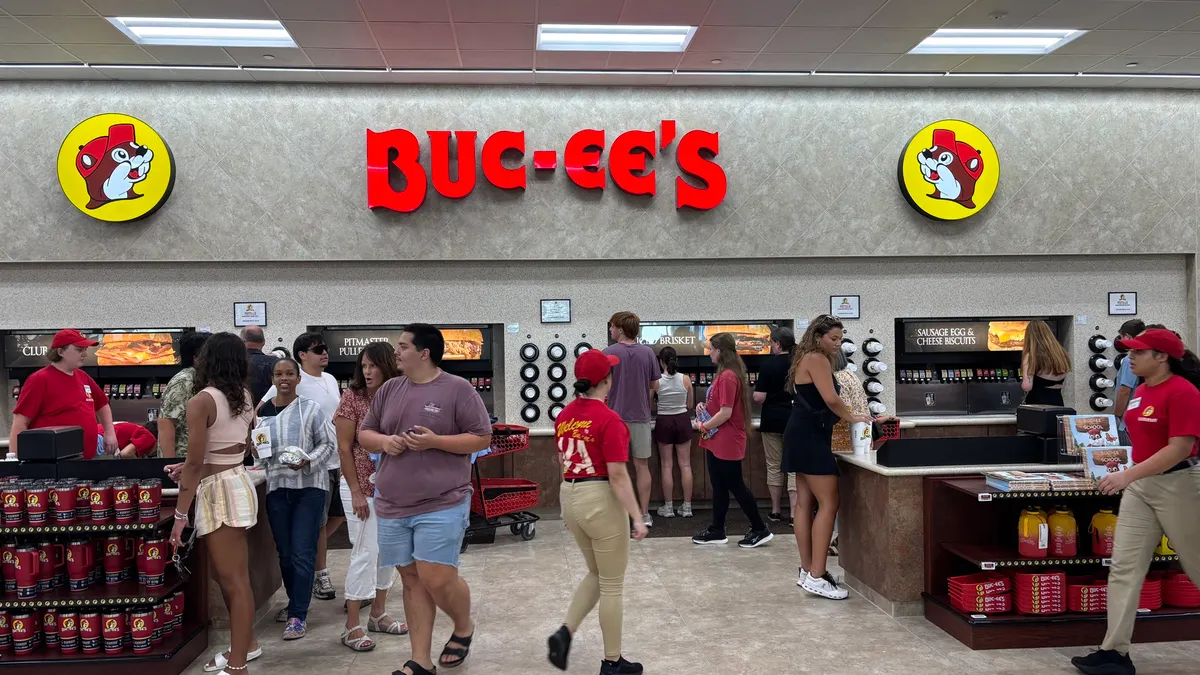 A photo of the interior of a large store. A bank of beverage dispensers lines the wall. A Sign over the machines reads "Buc-ee's."