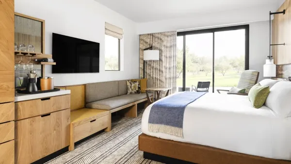 A bed in a hotel room.