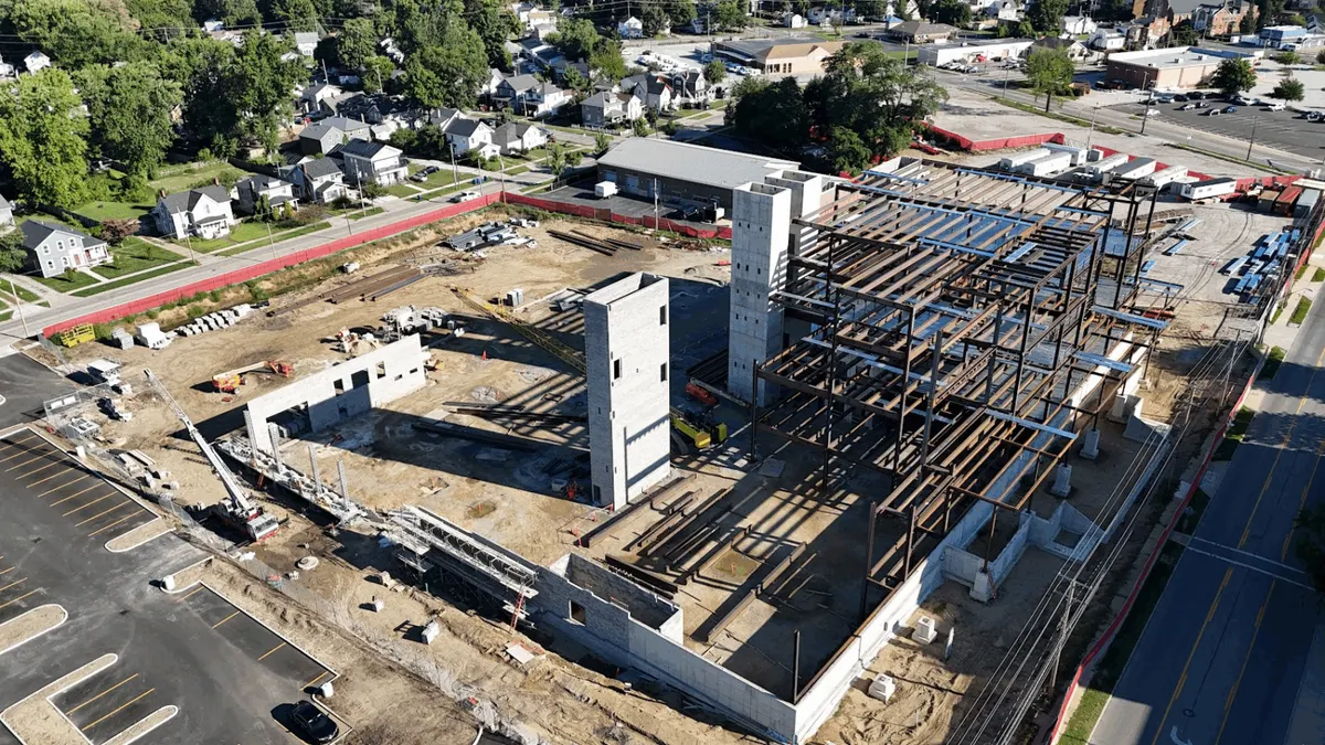 A shot from above of an under-construction building with its frame and foundation exposed.