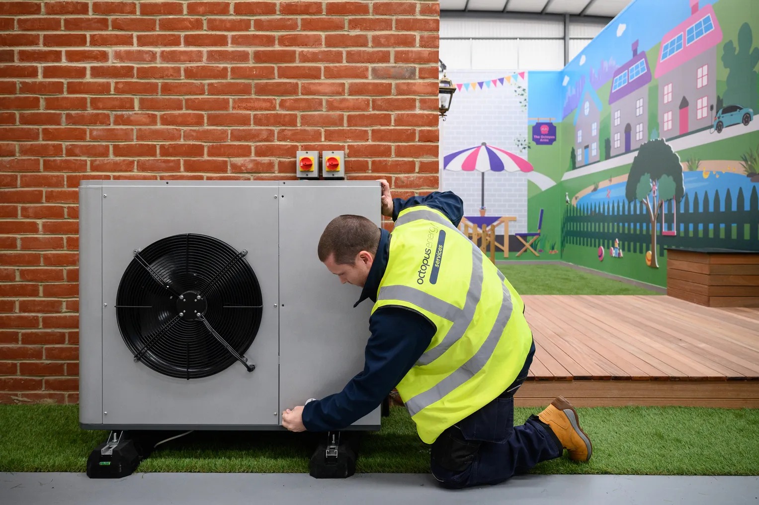 An engineer checks the installation of  heat pump on a model house.