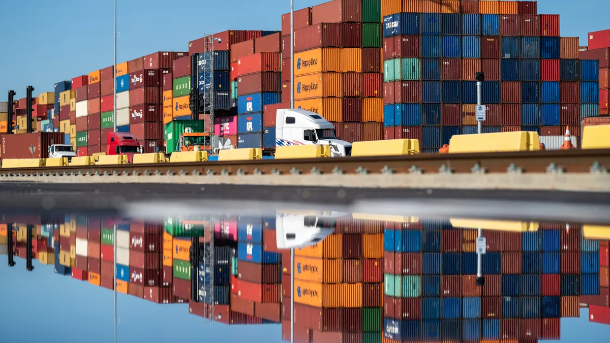 Trucks pass stacks of empty containers.