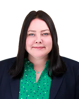 A portrait of a black-haired woman wearing a green shirt and a navy blazer.