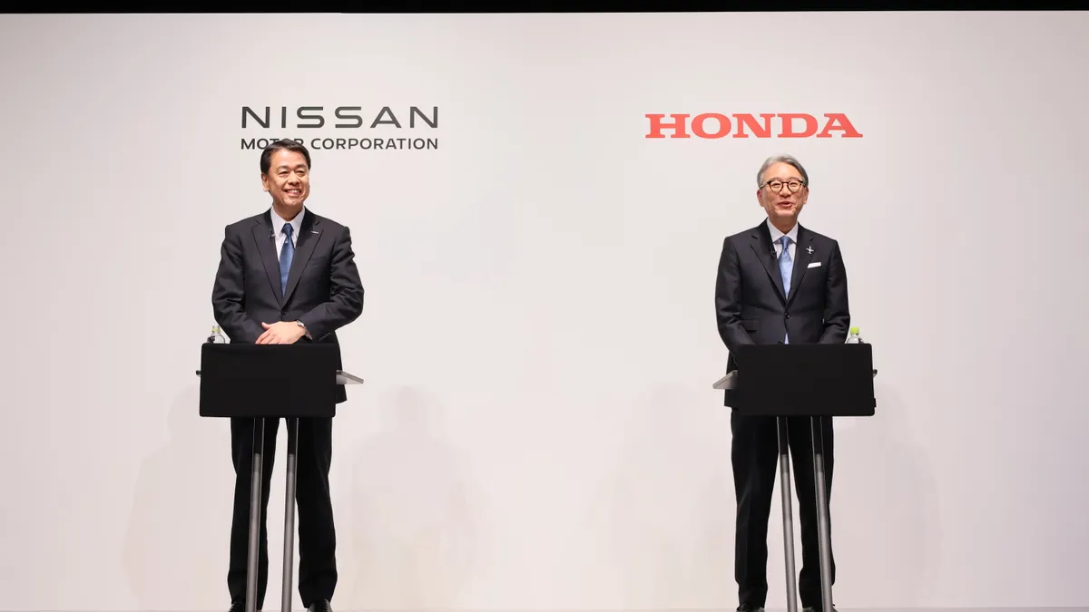 Nissan Motor Corp. President and CEO Makoto Uchida and Toshihiro Mibe, director, president and representative executive officer at Honda Motor Co., speak at a press conference.