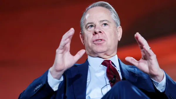 A man gestures while speaking