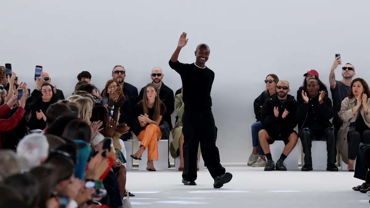 Maximilian Davis acknowledges the applause of the audience at the Ferragamo fashion show