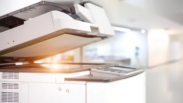 Close up picture of a photocopy and print machine in a workplace.