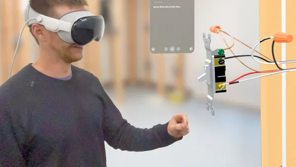 Person wearing VR head gear while doing some sort of training standing up.