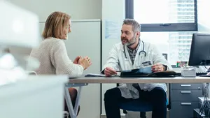 A patient and doctor talking at a table