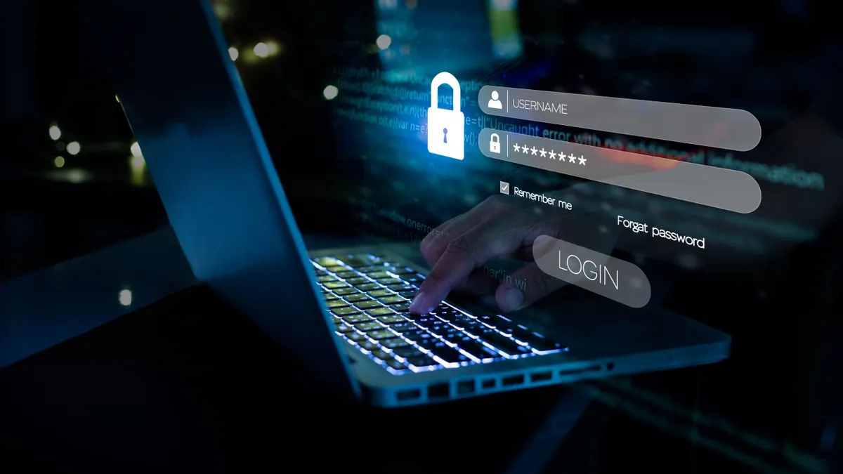 A hand typing login and password