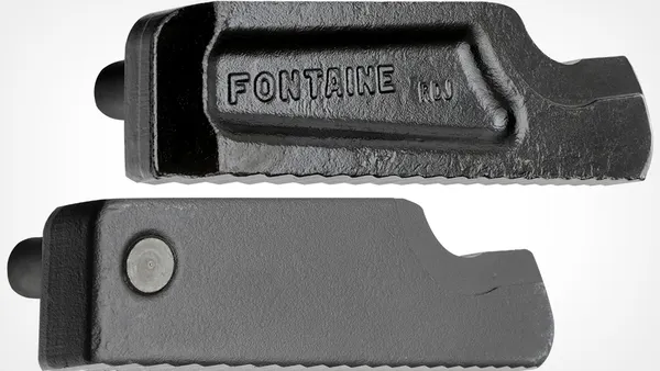 Two heavy-duty cast metal components, each with a rugged, toothed bottom edge.