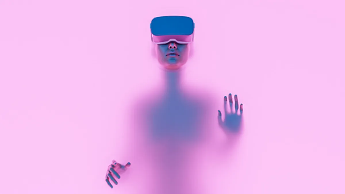 Person with VR googles on a pink background