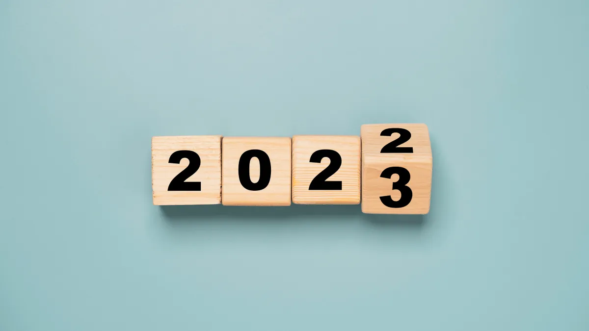 Wooden block cube flipping between 2022 to 2023