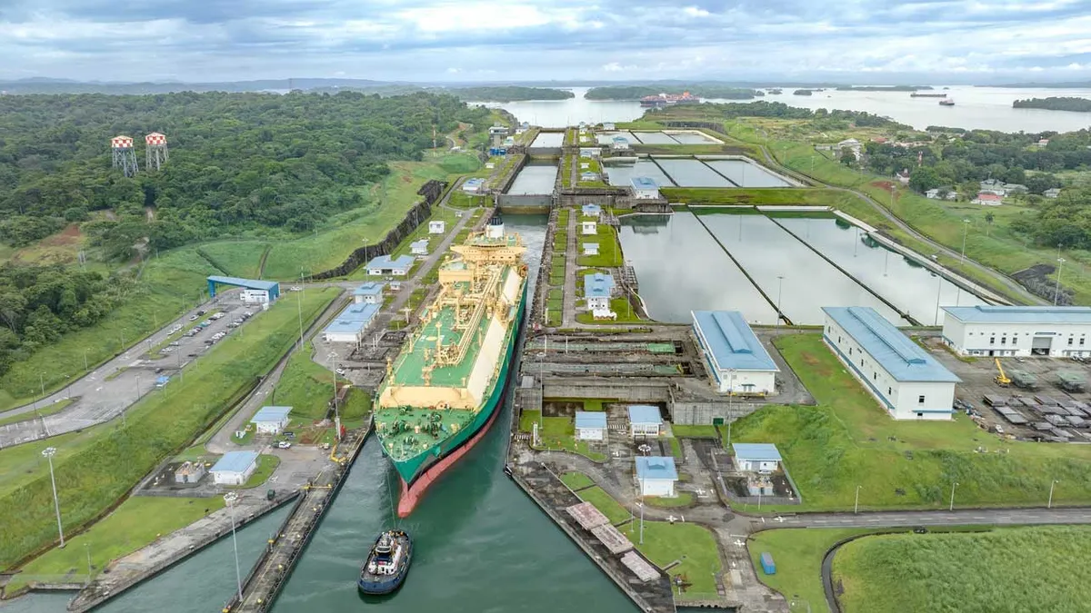 An oil tanker ship passes through the Panama Canal.