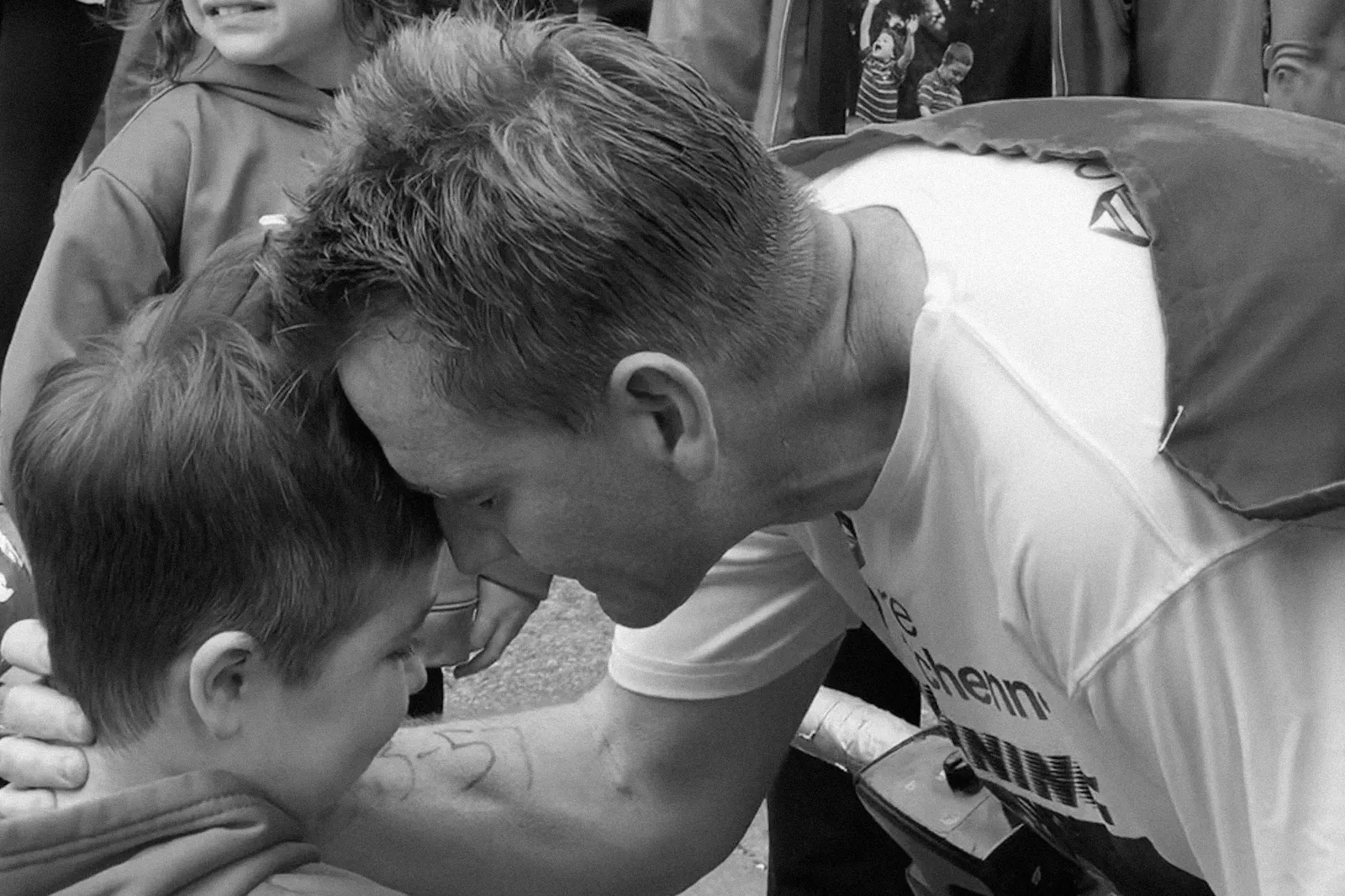 A man and a child embrace.