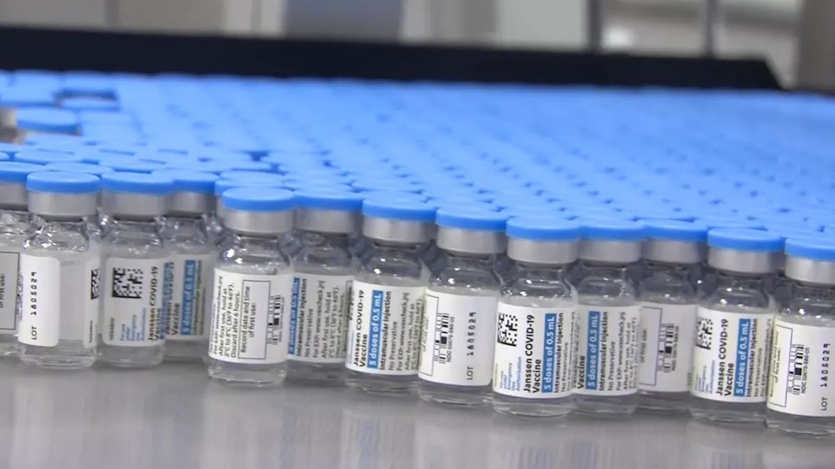 A still of COVID-19 vaccine vials from Johnson & Johnson going through production