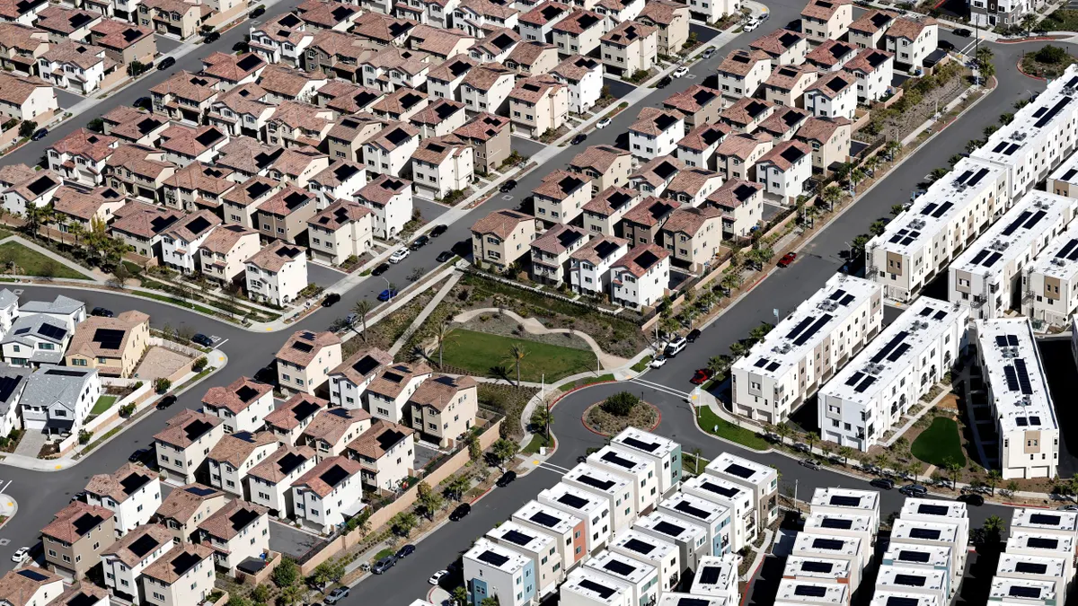 An aerial view of many houses with solar panels