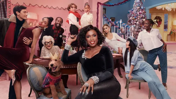 Jennifer Hudson sits in the center of a group of holiday party-goers in Old Navy's latest holiday campaign