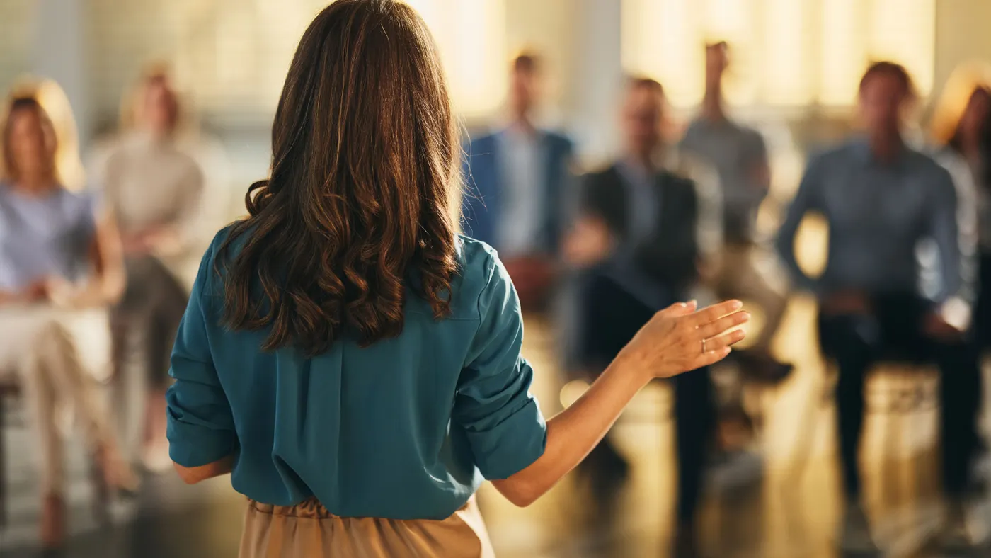 Back view of a businesswoman leading a seminar in board room. - stock photo