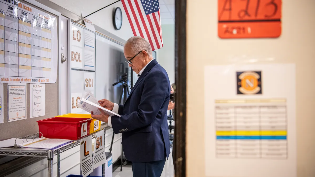 Houston Independent School District Superintendent Mike Miles examines a document during a visit to Navarro Middle School.