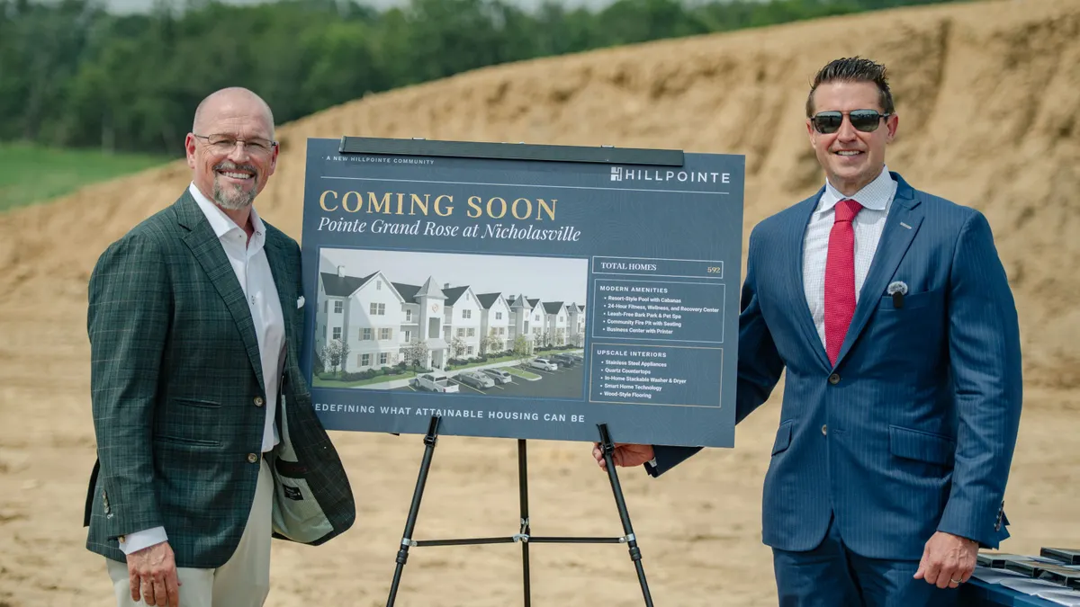Sign with a rendering of the upcoming Pointe Grand Citation at Lexington development at the groundbreaking event.