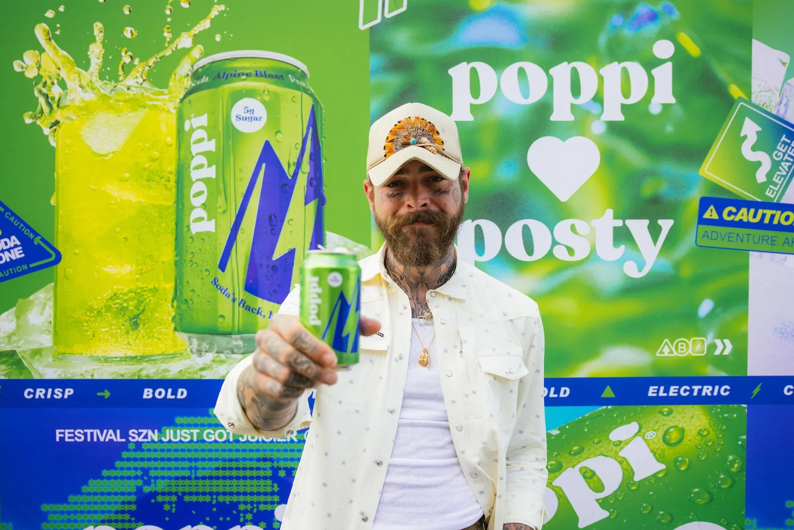 Post Malone holds a can of Poppi