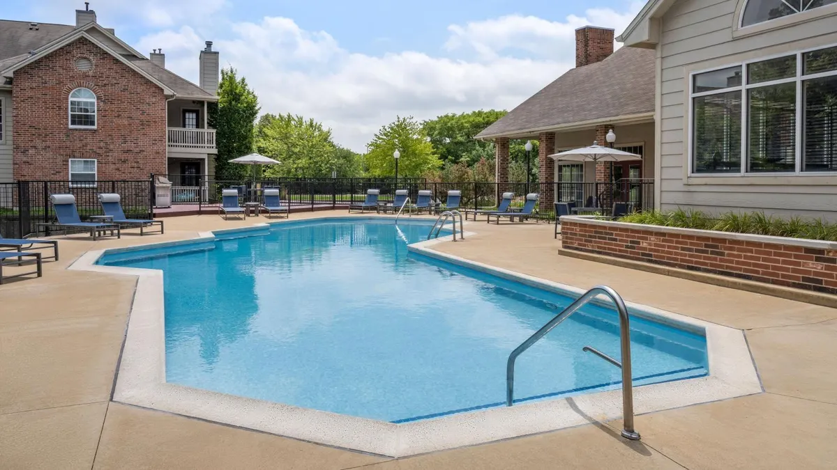 Pool surrounded by an apartment community