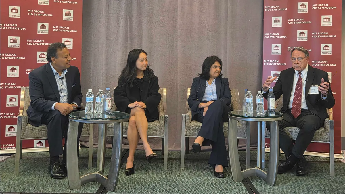 four executives speaking on a panel