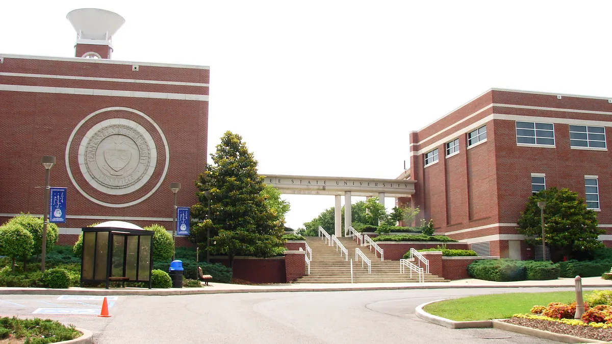 Two brick buildings connected by an overhang with Tennessee State University written across it.