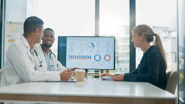 Doctors sitting at a table in a business meeting